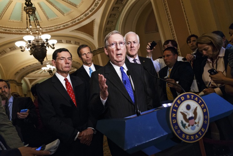 Senate Minority Leader Mitch McConnell and GOP lawmakers talk to reporters after a GOP caucus meeting, April 29, 2014.