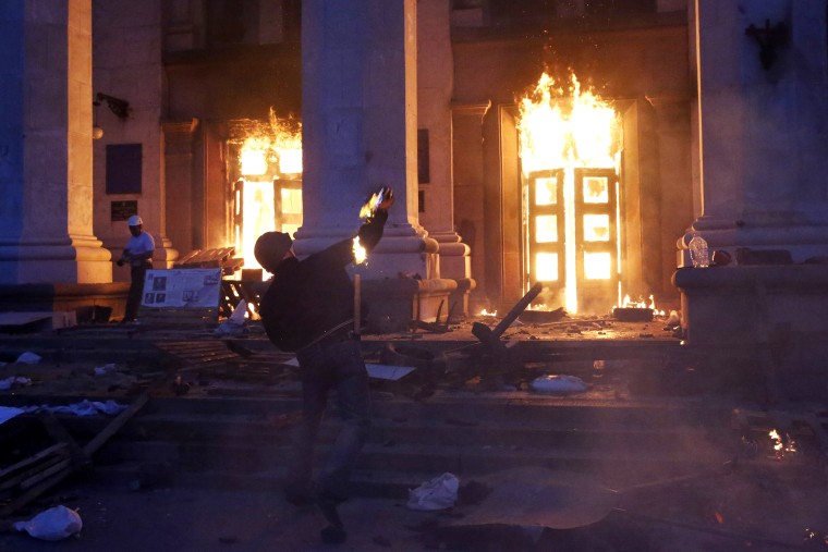 A protester throws a petrol bomb at the trade union building in Odessa May 2, 2014.