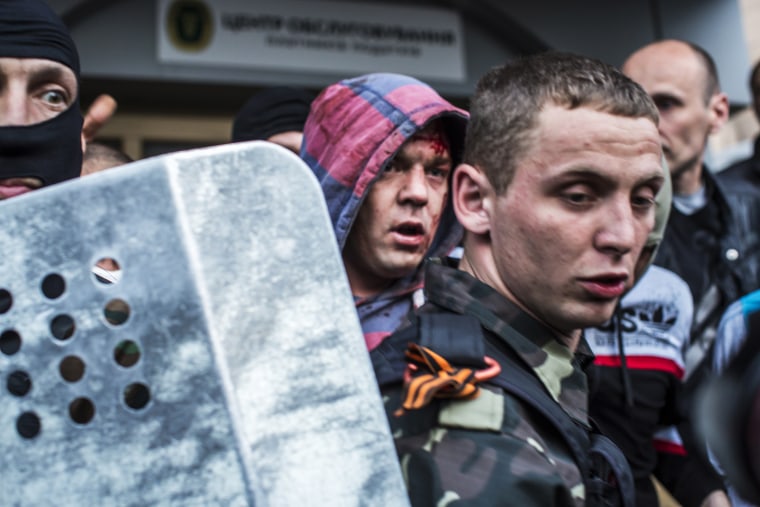 Pro-Russian protesters detain a man who was beaten and accused of being a provocateur outside the Executive Council building on May 4, 2014 in Donetsk, Ukraine.