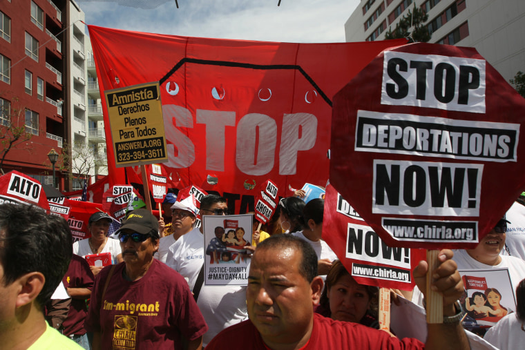 Marchers rally under the Chinatown Gateway during one a several May Day immigration-themed events on May 1, 2014 in Los Angeles, California.