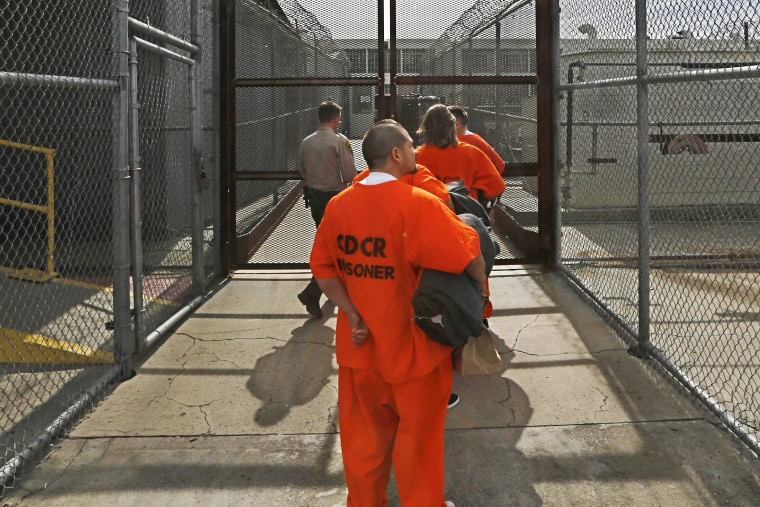 New arrivals to the Deuel Vocational Institution are taken inside the prison near Tracy, Calif., Feb. 20, 2014.