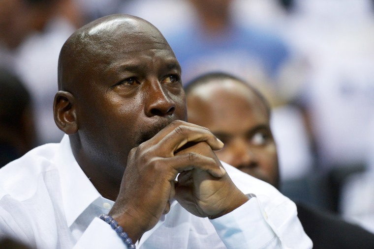 Michael Jordan watches as the Charlotte Bobcats play the Miami Heat, April 26, 2014 in Charlotte, North Carolina.