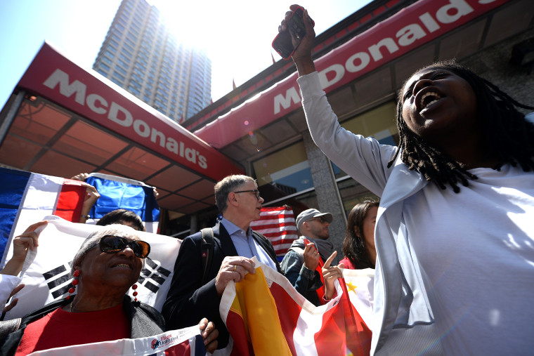 Fast-food workers from around the world stage a protest in front of a McDonald's restaurant, campaigning for higher pay, in New York on May 7, 2014