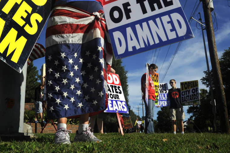 Members of the Westboro Baptist Church picket a city park near their church in Topeka, Kan.