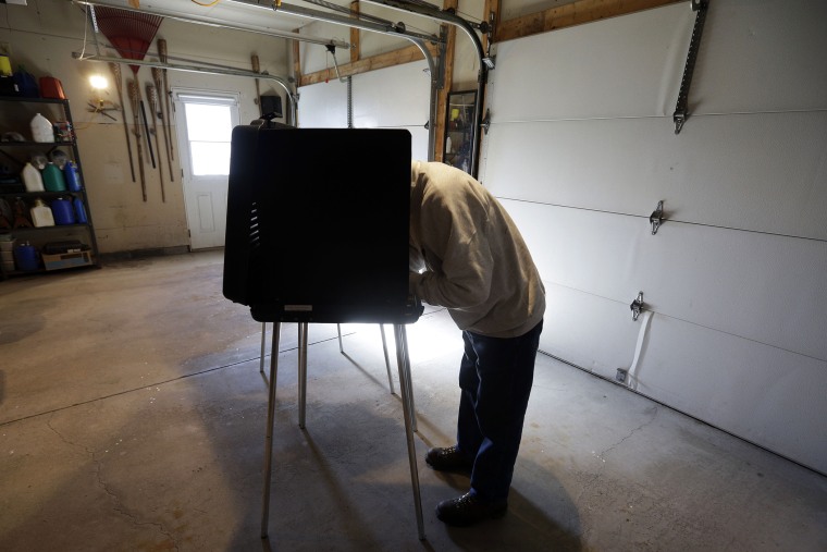 A man casts his vote at a polling place inside a residential garage, Nov. 6, 2012, in Forest City, Pa.