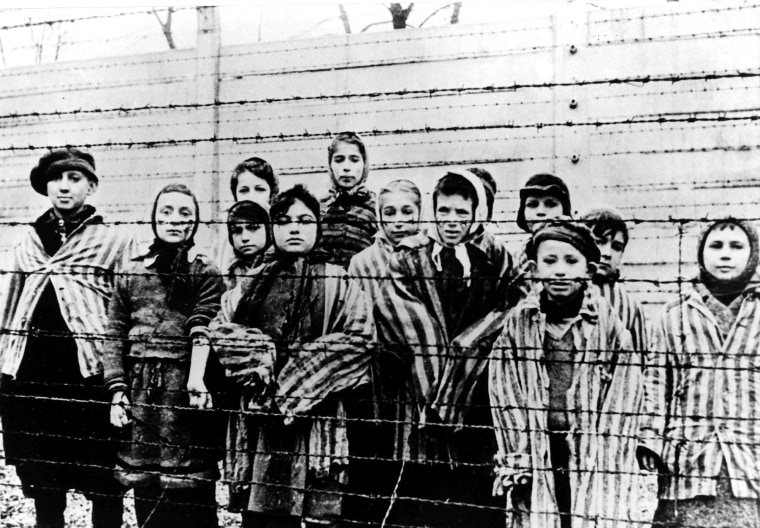 A picture taken just after the liberation by the Soviet army in January, 1945, shows a group of children wearing concentration camp uniforms behind barbed wire fencing in the Auschwitz Nazi concentration camp.
