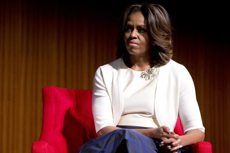 First lady Michelle Obama looks to President Barack Obama as he speaks at the LBJ Presidential Library, April 10, 2014, in Austin, Texas.