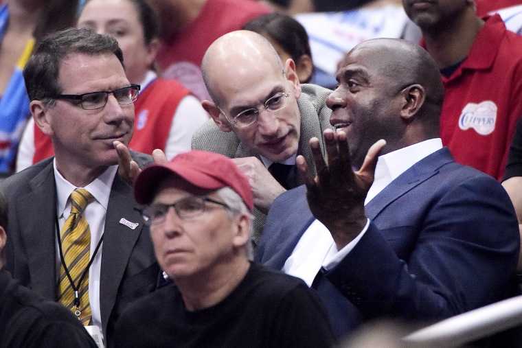 NBA Commissioner Adam Silver talks with Magic Johnson as the Los Angeles Clippers play the Oklahoma City Thunder, May 11, 2014.