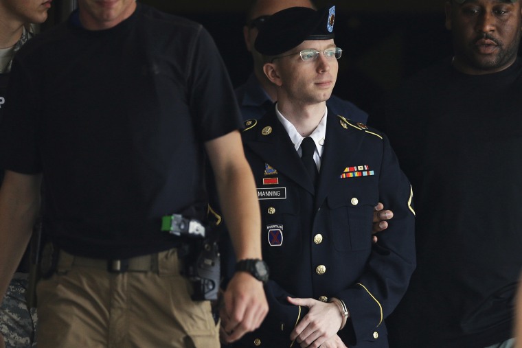 Chelsea Manning is escorted out of a courthouse in Fort Meade, Md., July 30, 2013.
