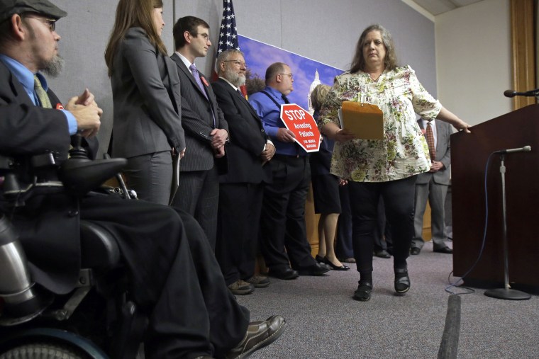 Joni Whiting, right, of Jordan, Minn., leaves the podium after encouraging support of a bill to legalize medical marijuana in Minnesota during a State Capitol news conference on May 2, 2013 in St. Paul, Minn.