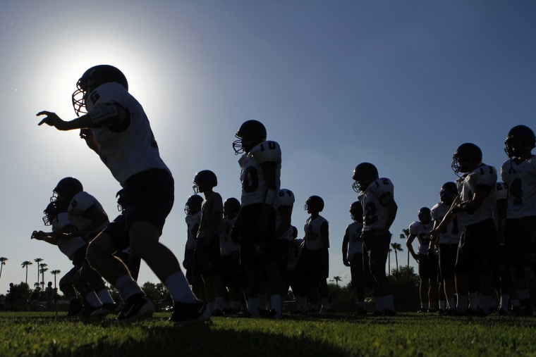 A high school football team practices for their upcoming season in Arizona.
