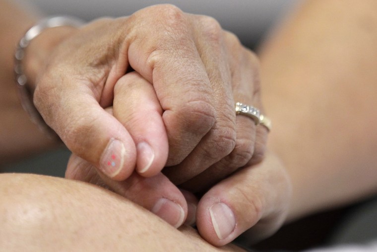 Ellen Toplin and Charlene Kurland hold hands as they obtain a marriage license at a Montgomery County office despite a state law banning such unions, Wednesday, July 24, 2013, in Norristown, Pa.