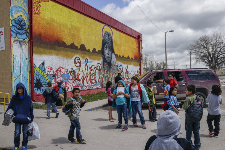 Students leave class and wait for the bus on the last day of classes at the Wounded Knee District School in Manderson, South Dakota.