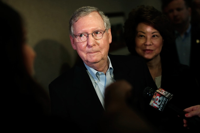 Senate Republican Leader Sen. Mitch McConnell (R-KY) answers questions  while speaking to the press at at a campaign rally with his wife Elaine Chao (R) May 19, 2014 in Louisville, Ky.