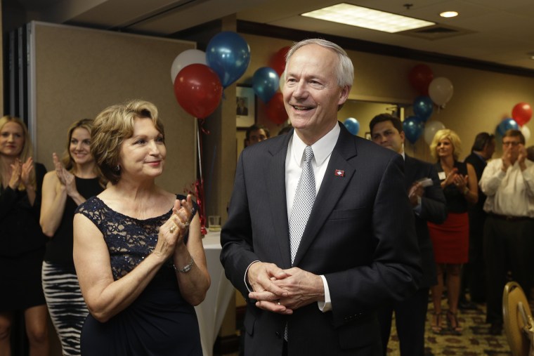 Asa Hutchinson, right, is applauded by his wife Susan and others as early vote totals are announced inLittle Rock, Ark., Tuesday, May 20, 2014.