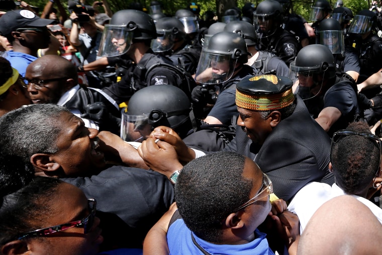 Demonstrators clash with police during a protest at the McDonald's headquarters in Oak Brook