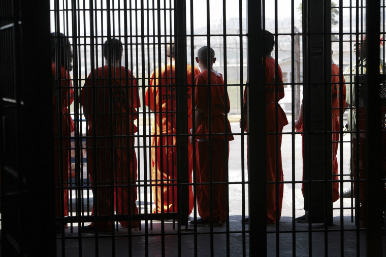 Inmates wait to be transported for medical screening after arriving at the California Institution for Men in Chino, Calif.