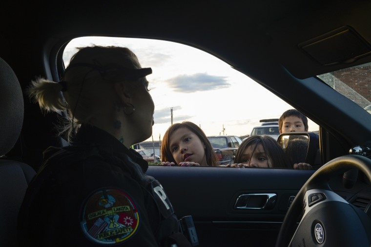 Officer Becky Sotherland talks to local kids while on a patrol in Manderson.