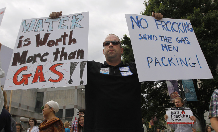 Robert Alpaugh holds signs during a march down the Bicentennial Mall to the Legislative Building in Raleigh, N.C., Tuesday, June 5, 2012.