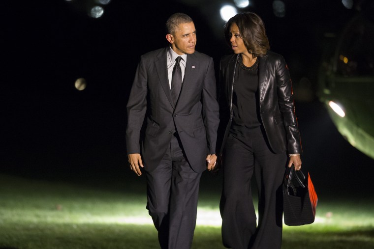 President Barack Obama and first lady Michelle Obama walk to the White House after arriving on the South Lawn, April 12, 2014, in Washington, D.C.