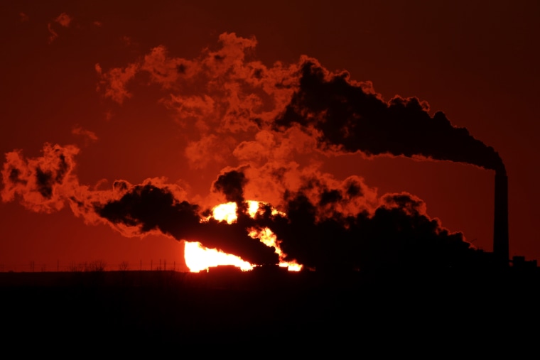 In this March 8, 2014 file photo steam a coal-fired power plant is silhouetted against the setting sun near St. Marys, Kan.