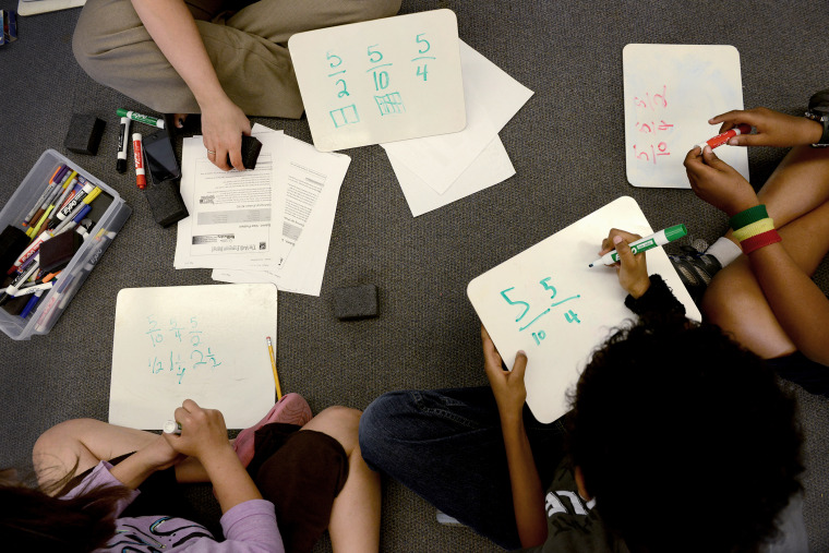 A teacher goes over fractions with her students in fourth grade math class at Piney Branch Elementary School in Takoma Park, Md. on May 16, 2013.