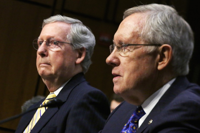 Senate Majority Leader Harry Reid (D-NV) (R) and Senate Minority Leader Mitch McConnell (R-KY) testify before the Senate Judiciary Committee about political donations and freedom of speech in the Hart Senate Office Building June 3, 2014 in Washington, DC.