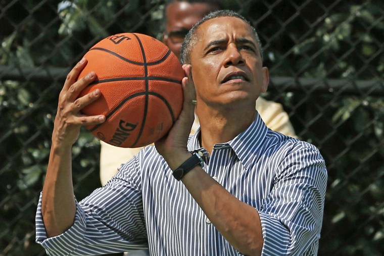 U.S. President Barack Obama plays basketball during the annual Easter Egg Roll on the White House tennis court April 1, 2013 in Washington, DC.
