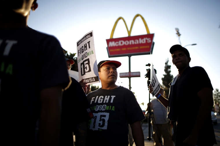 Demonstrators take part in a protest to demand higher wages for fast-food workers outside McDonald's in Los Angeles