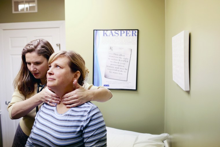 Dr. Tracy Ragland, a pediatrician and family practitioner, examines patient Kelli Van Zant at her private practice in Crestwood, Ky.