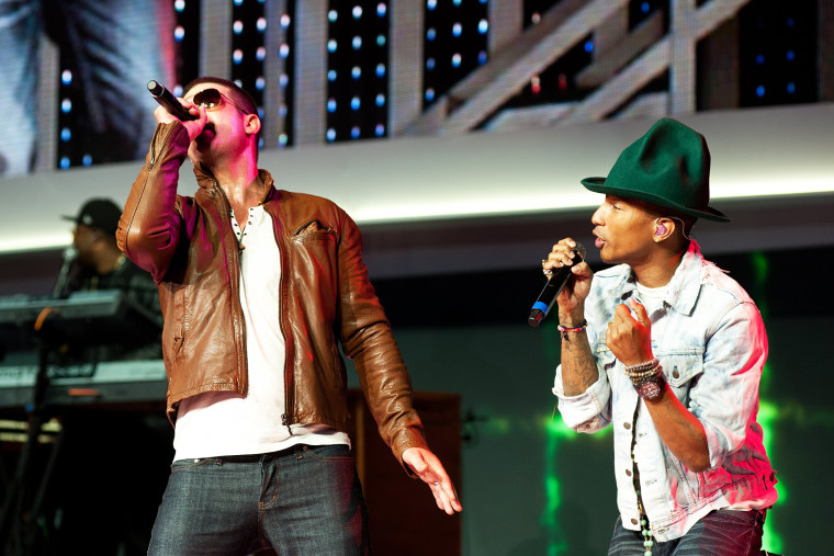 Robin Thicke, left, performs on stage with Pharrell Williams, at the annual Wal-Mart Shareholders meeting in Fayetteville, Ark., June 6, 2014.
