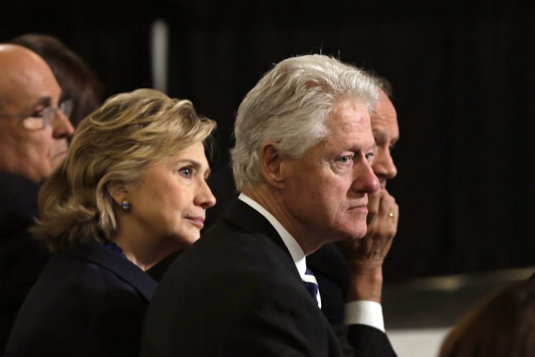 Bill and Hillary Clinton listen to ceremonies during the National September 11 Memorial Museum dedication ceremony on May 15, 2014 in New York City.