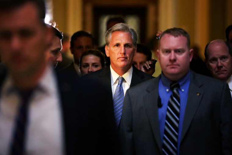 U.S. House Majority Whip Rep. Kevin McCarthy (R-CA) (C) passes through the Statuary Hall of the Capitol after a vote on the House floor, June 11, 2014.