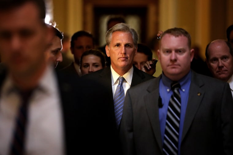 U.S. House Majority Whip Rep. Kevin McCarthy (R-CA) (C) passes through the Statuary Hall of the Capitol after a vote on the House floor June 11, 2014 on Capitol Hill in Washington, DC.