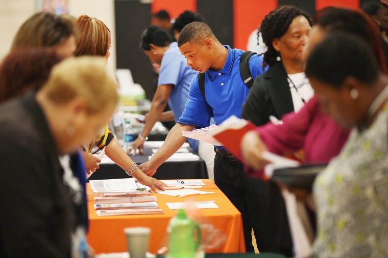 Job seekers check out opportunities at a job fair on June 12, 2014 in Chicago, Illinois.