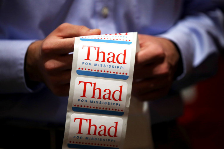 A campaign worker for U.S. Sen Thad Cochran (R-MS) passes out campaign stickers on June 23, 2014 in Jackson, Mississippi.