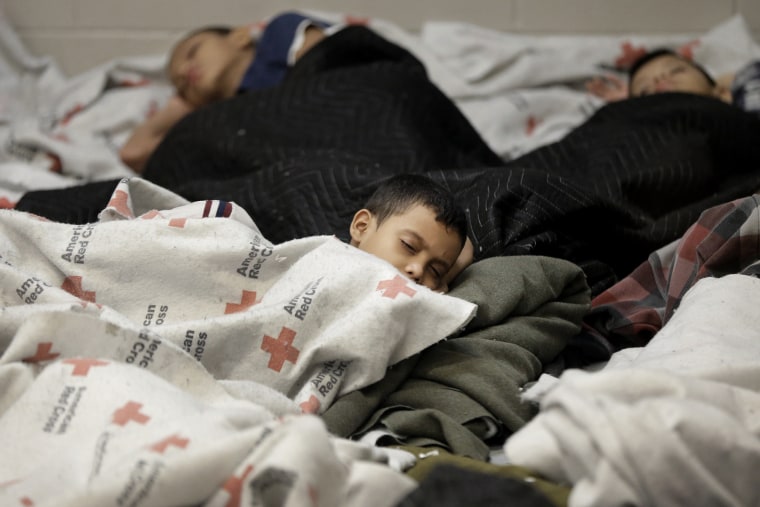 Detainees sleep in a holding cell at a U.S. Customs and Border Protection processing facility, Wednesday, June 18, 2014, in Brownsville,Texas.