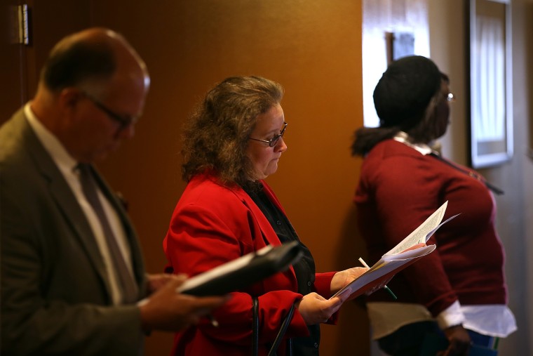 Job seekers fill out applications before the start of the HireLive career fair on June 4, 2014 in San Francisco, Calif.