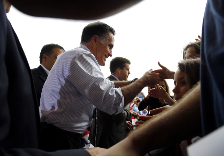 Republican presidential nominee Romney greets audience members at a campaign rally at the airport in Sanford