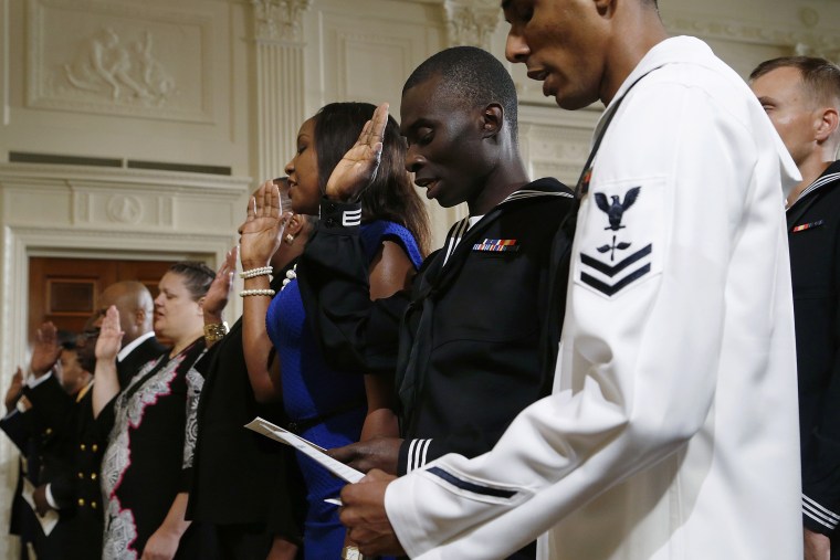 Members of the U.S. military and military spouses recite the Oath of Allegiance to become naturalized U.S. citizens during a ceremony hosted by U.S. President Barack Obama (not pictured) at the White House in Washington July 4, 2014.