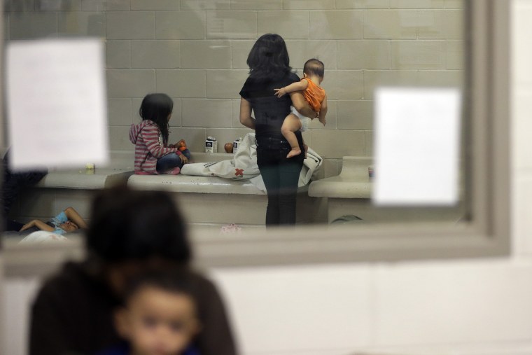 Detainees wait in a holding cell at a U.S. Customs and Border Protection processing facility, June 18, 2014, in Brownsville, Texas.