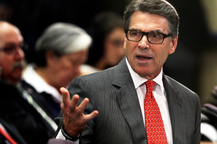 Texas Gov. Rick Perry talks to members of the U.S. House Committee on Homeland Security about the humanitarian and national security crises going on along the Texas-Mexico border, July 3, 2014 in McAllen, Texas.