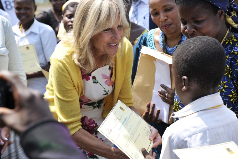 Dr. Jill Biden, wife of the US vice-president, hands a diploma to a student as representatives of the Anunciata non-governmental organization (NGO) look on, after she arrived at the airport of Bukavu, in eastern Democratic Republic of Congo, on July 5, 20