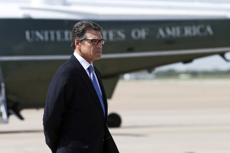 Texas Governor Rick Perry awaits the arrival of U.S. President Barack Obama in Dallas, July 9, 2014.