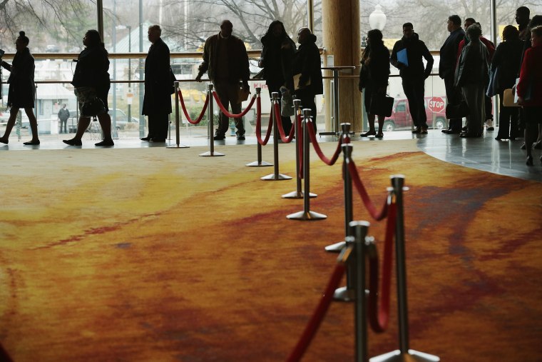 About 1,500 people seeking employment wait in line to enter a job fair, March 28, 2014 in Washington, D.C.