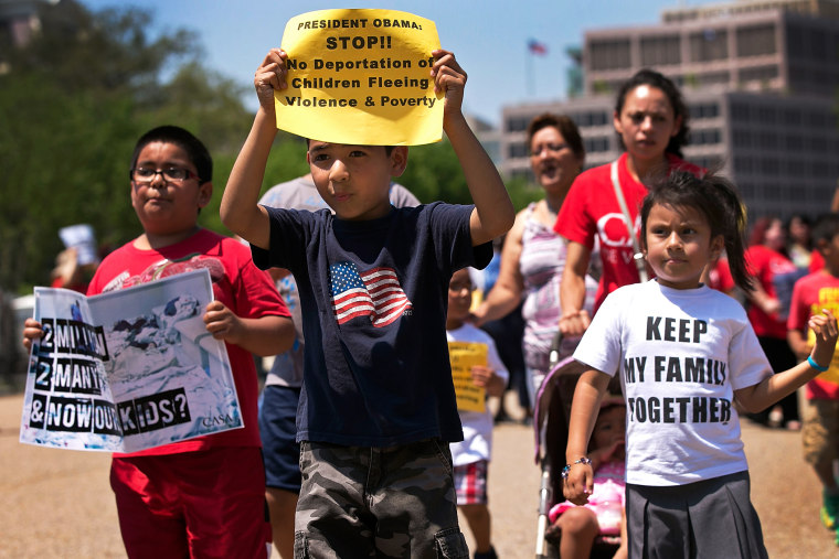 Young children join immigration reform protesters while marching in front of the White House July 7, 2014 in Washington, DC.