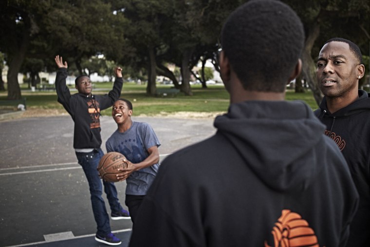 Former NFL player William Blackwell mentors 10th grade students at the De Fremery Park in West Oakland, California, July 7, 2014.