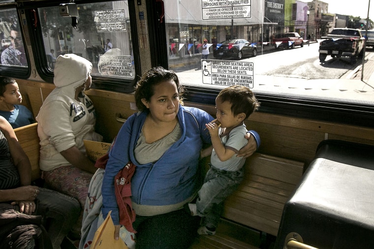 Marta Beltran, 19, of El Salvador, holds her 18-month-old son, Lenny, as they ride a city shuttle bus from the McAllen city bus station to the Sacred Heart Catholic Church Shelter in McAllen, Texas on July 4, 2014.
