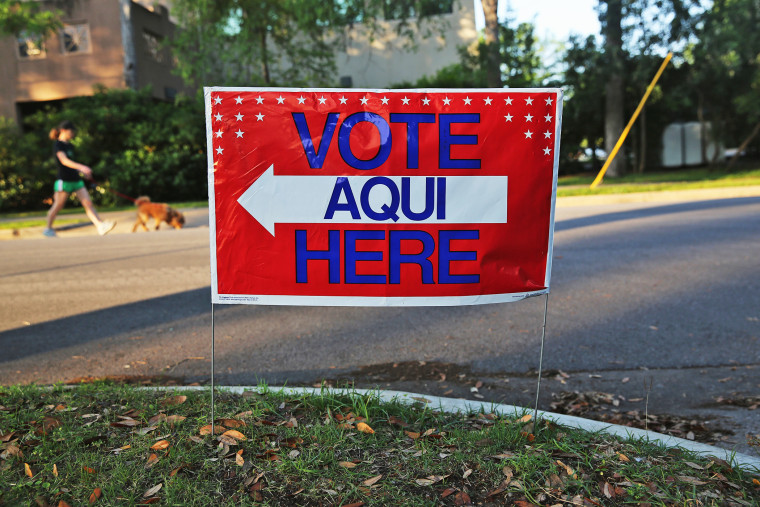 A bilingual sign stands outside a polling center at public library ahead of local elections on April 28, 2013 in Austin, Texas.