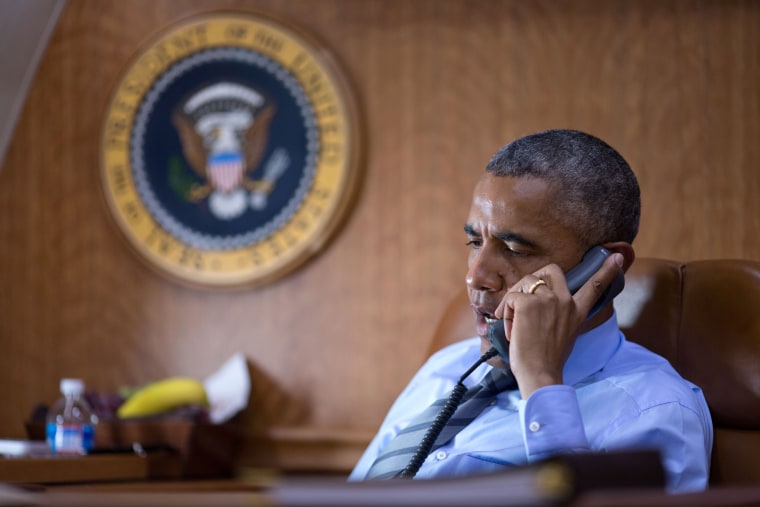 President Barack Obama talks on the phone aboard Air Force One with President Petro Poroshenko of Ukraine about the Malaysia Airlines plane crash in eastern Ukraine on July 17, 2014.
